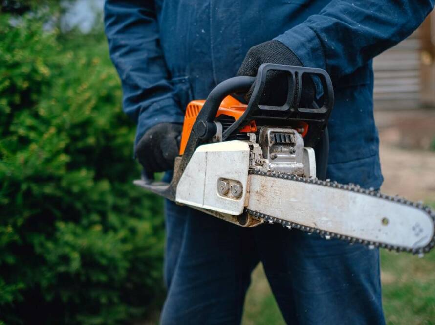 A tree service professional using trimming equipment